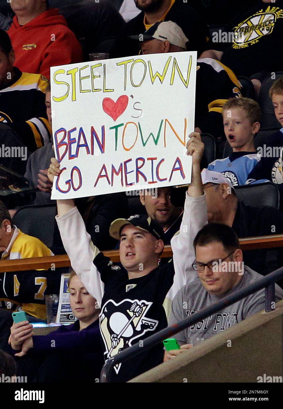 A Pittsburgh Penguins fan holds a sign that in support of Boston during