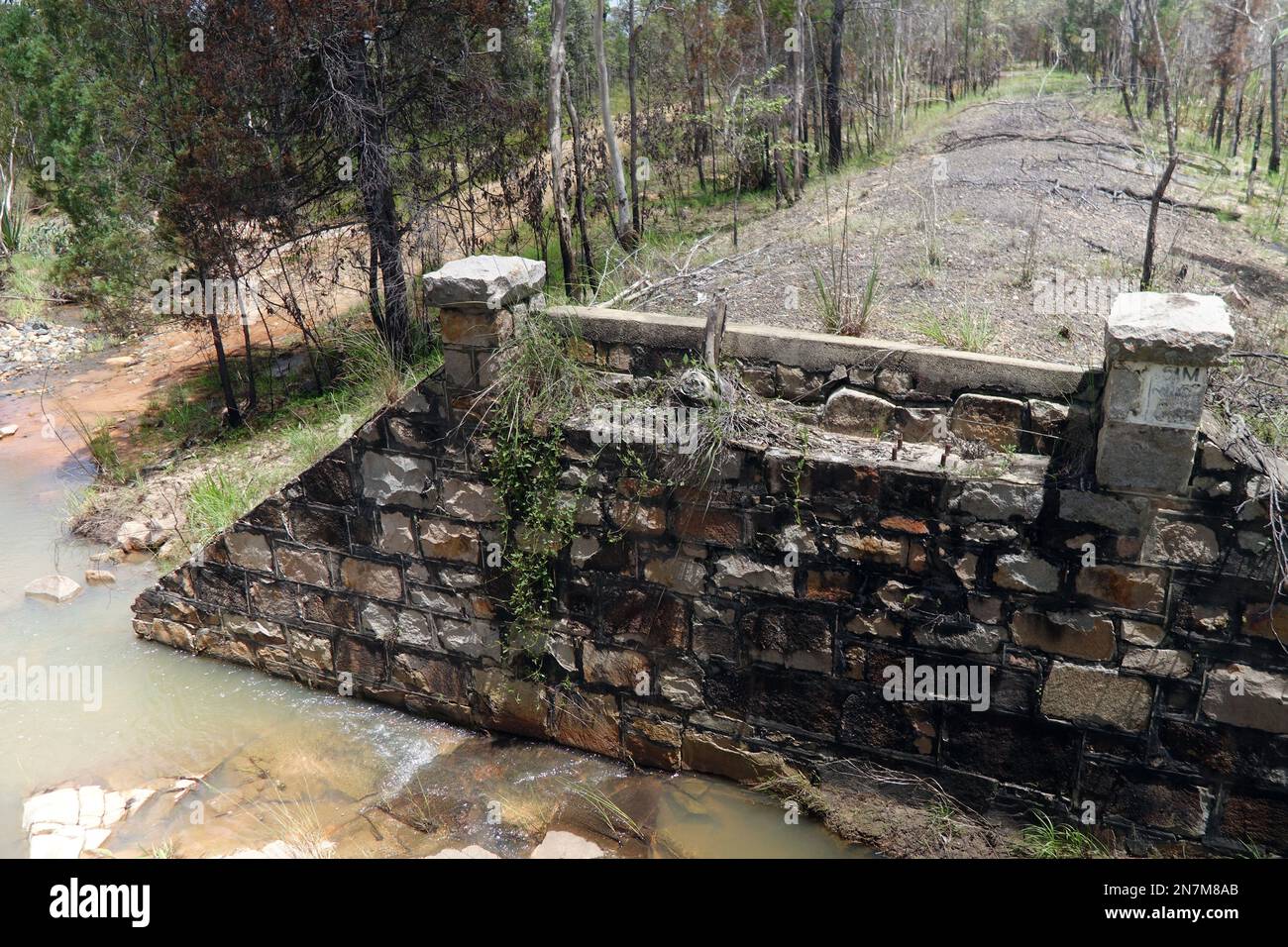 Remains of stone railway bridge over creek, Nymbool Road, near Petford, outback Queensland, Australia Stock Photo