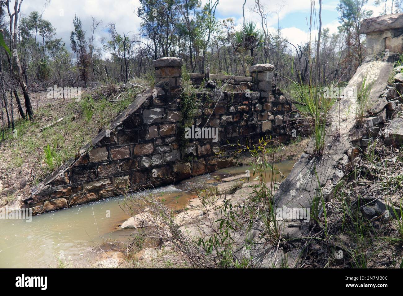Remains of stone railway bridge over creek, Nymbool Road, near Petford, outback Queensland, Australia Stock Photo