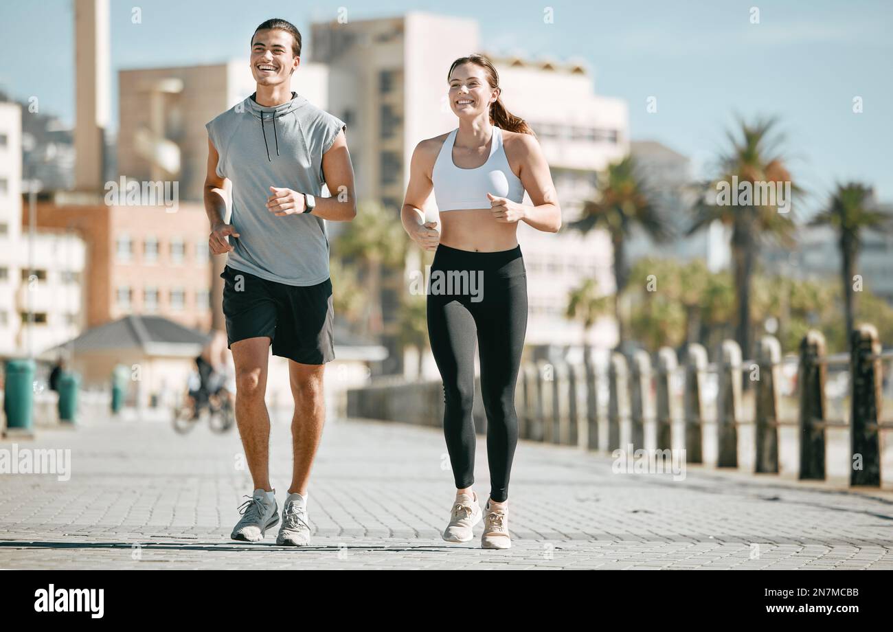 Couple, fitness and running together in the city for exercise, workout ...