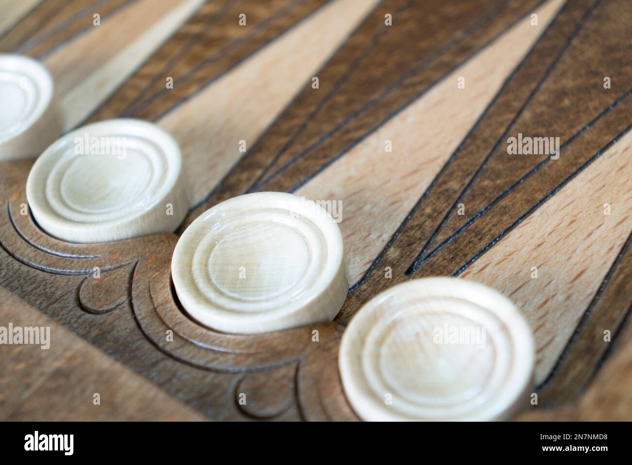 Closeup of backgammon board game. Wooden backgammon board with checkers and dice pair Stock Photo