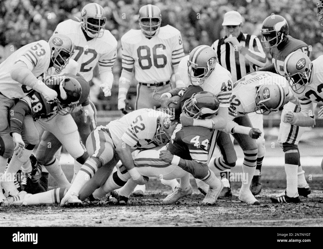 Minnesota Vikings running back Chuck Foreman (44) gets a heck of a tackle  from San Francisco 49ers free safety Ralph McGill after making a seven-yard  gain in the first half of their