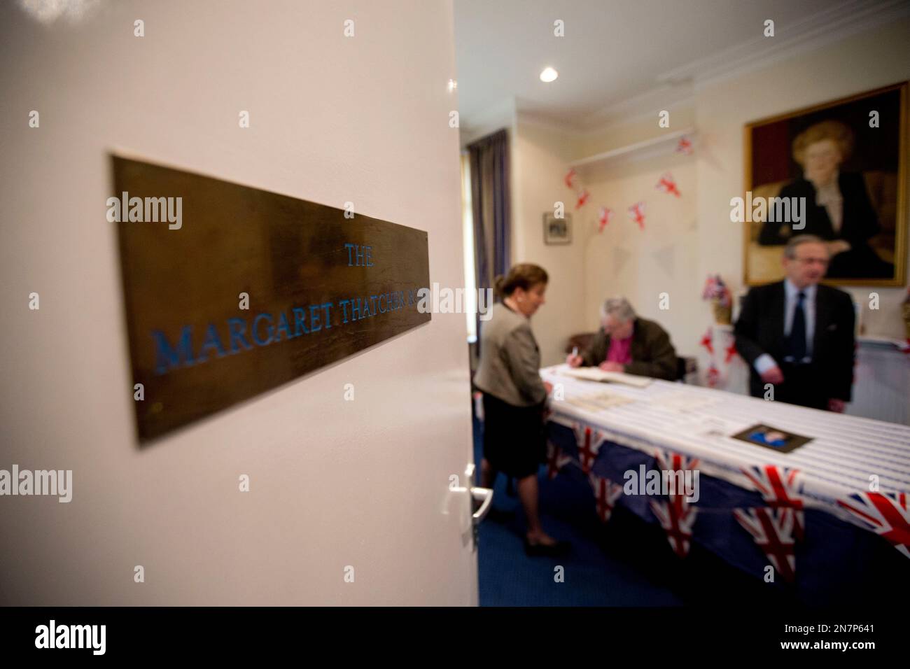 A local resident signs a book of condolence for the late former British