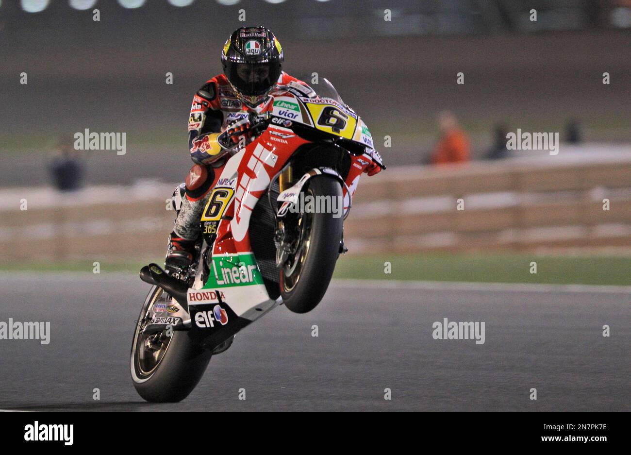 German MotoGP rider Stefan Bradl of the LCR Honda MotoGP team pulls a wheelie after the qualifying session a day ahead of Sundays Qatar Moto GP, at the Losail International Circuit, Saturday,
