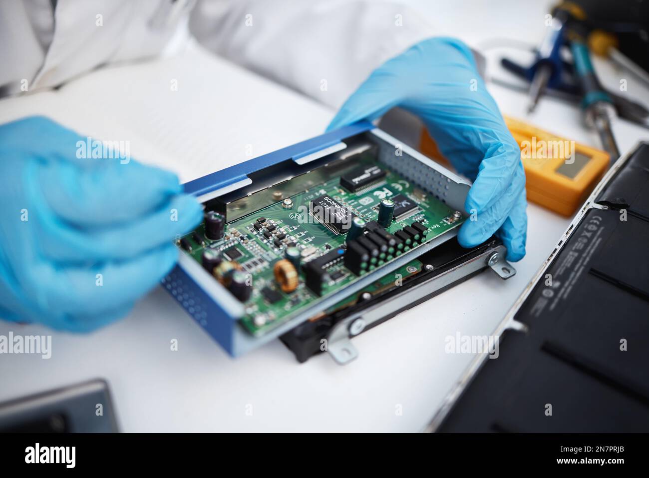 Computer hardware, repair and hands of engineer working on electronic
