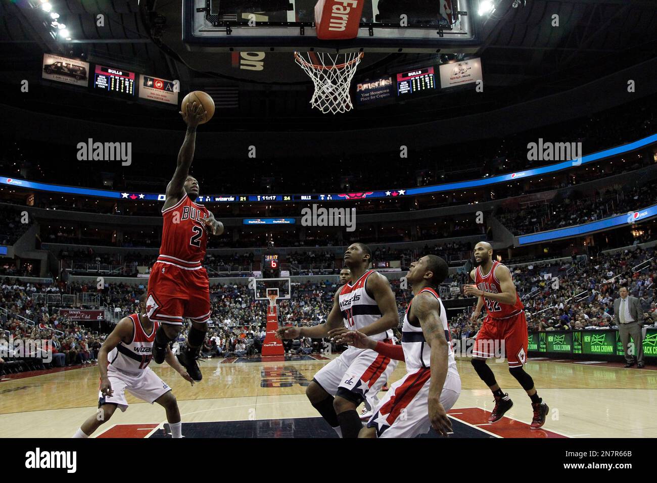 Chicago Bulls guard Nate Robinson (R) looks up at the scoreboard as referee David Guthrie stands on the floor during the fourth quarter of Game 3 of the NBA Eastern Conference semifinals