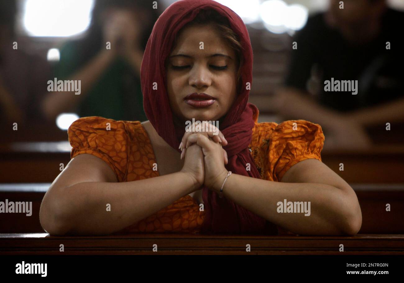 A woman offers prayers at a church on Easter Sunday, the most holy day