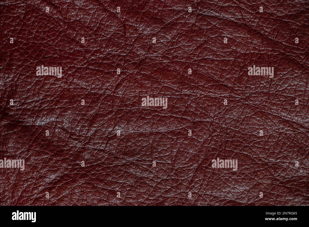 dark red genuine leather as a close up background Stock Photo