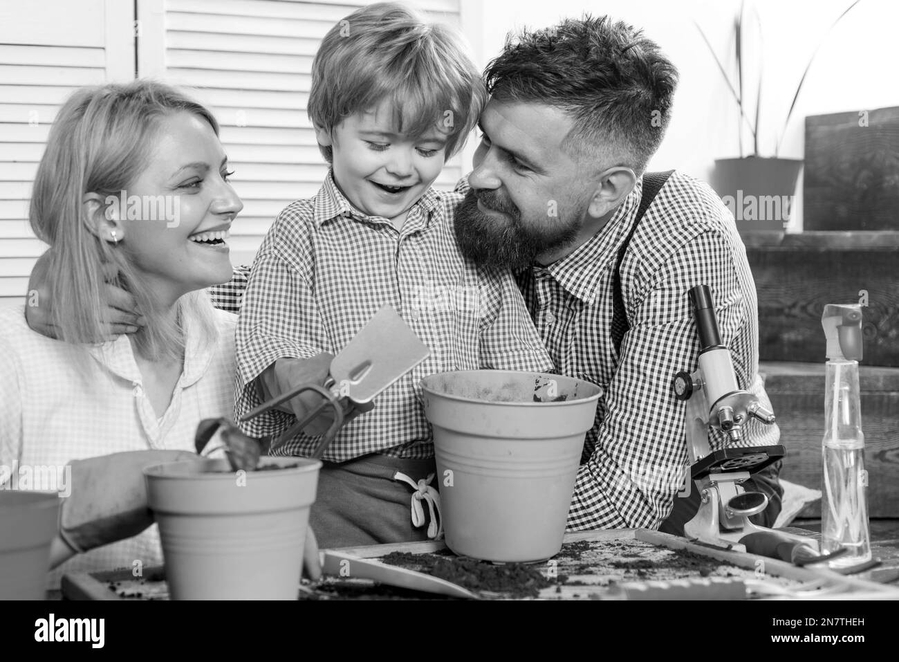 Little cute boy helps his parents. Teamwork and family togetherness concept. Environment protection and saving ecology starts from us. Happy family Stock Photo