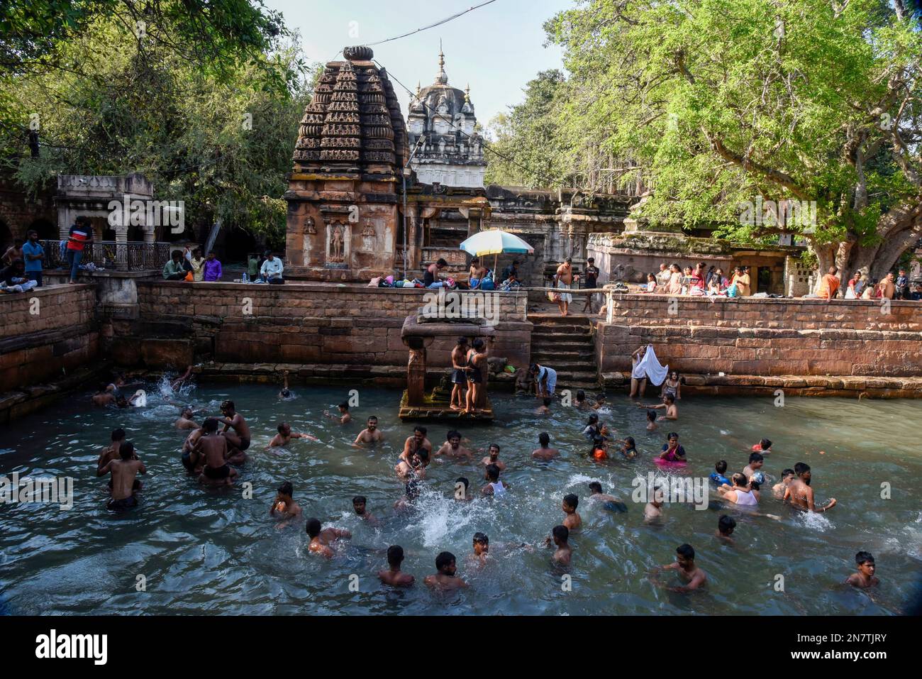 Bagalkot, Karnataka, India - Oct 26 2022: People bathing in the temple tank of Mahakuta temples built by the early Chalukya kings. Stock Photo