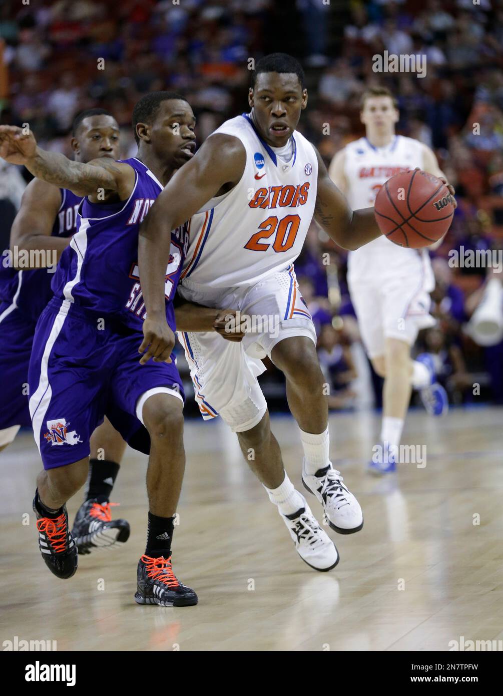 Florida's Michael Frazier II (20) drives around Northwestern State's ...
