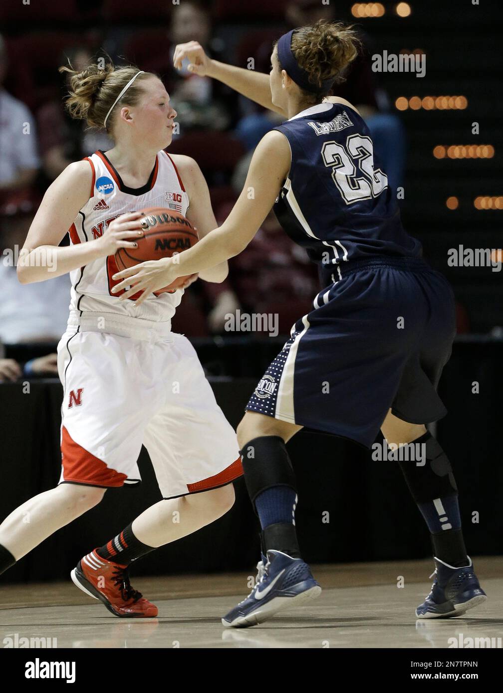 Nebraska's Lindsey Moore, left, tries to get past Chattanooga's Kylie Lambert (22) during the first half of a first-round game in the NCAA womens' college basketball tournament in College Station, Texas, Saturday, March 23, 2013. (AP Photo/Pat Sullivan) Stock Photo