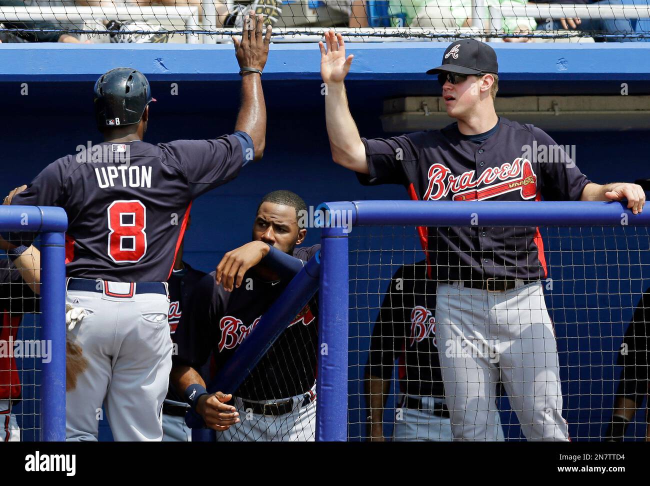 Teammates greet Atlanta Braves Justin Upton (8) after he scored on