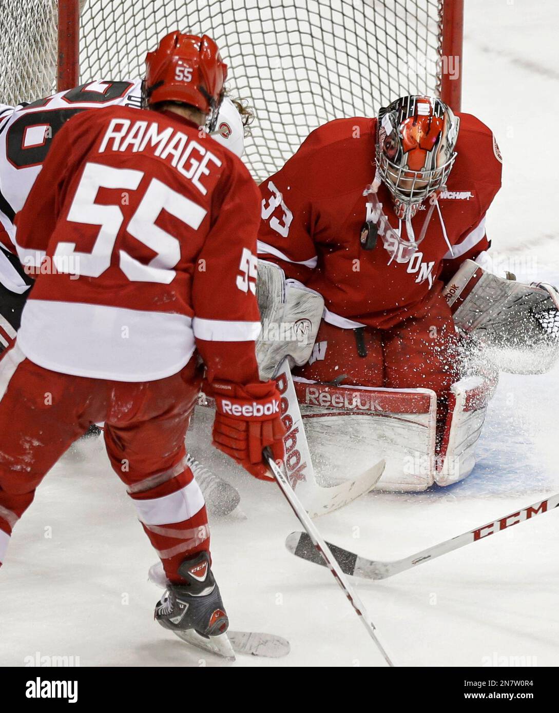 Wisconsin goalie Joel Rumpel, right, stops a shot by St. Cloud State's ...