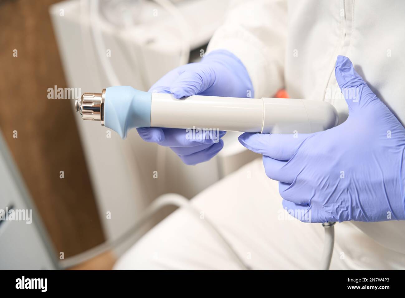 Doctor holding part of shock wave therapy devices in the hospital Stock Photo