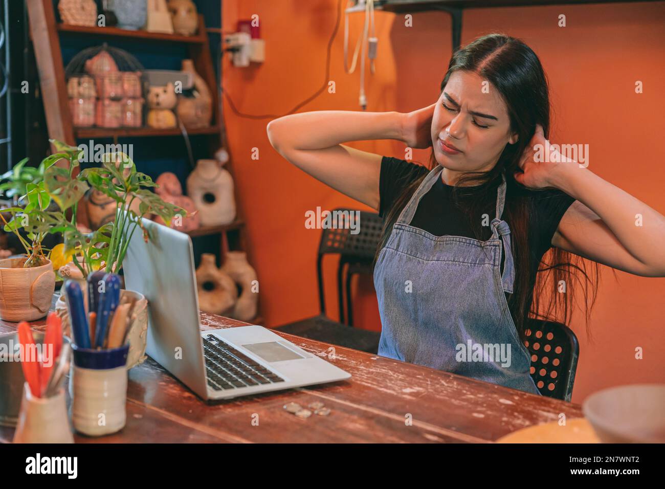 artist pot handcraft seller business owner tired stress from hard working overnight. woman muscle pain Stock Photo