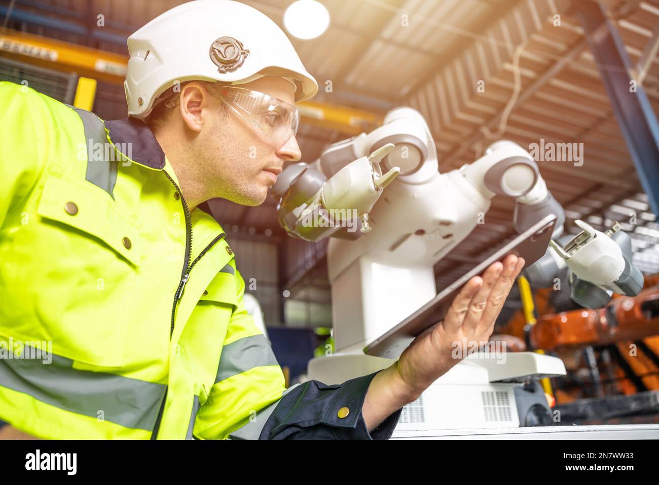 Automation Engineer Service Programming Robotic Arm. New Era Modern Machine Automatic Manufacturing Industry Concept. Stock Photo