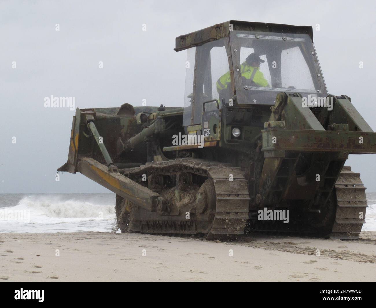a-public-works-employee-uses-a-bulldozer-to-rebuild-a-sand-dune-in