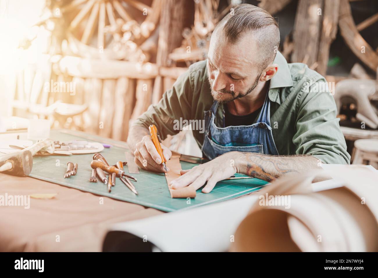 Leather maker artist handcraft working at own workshop small studio made by order masterwork piece Stock Photo