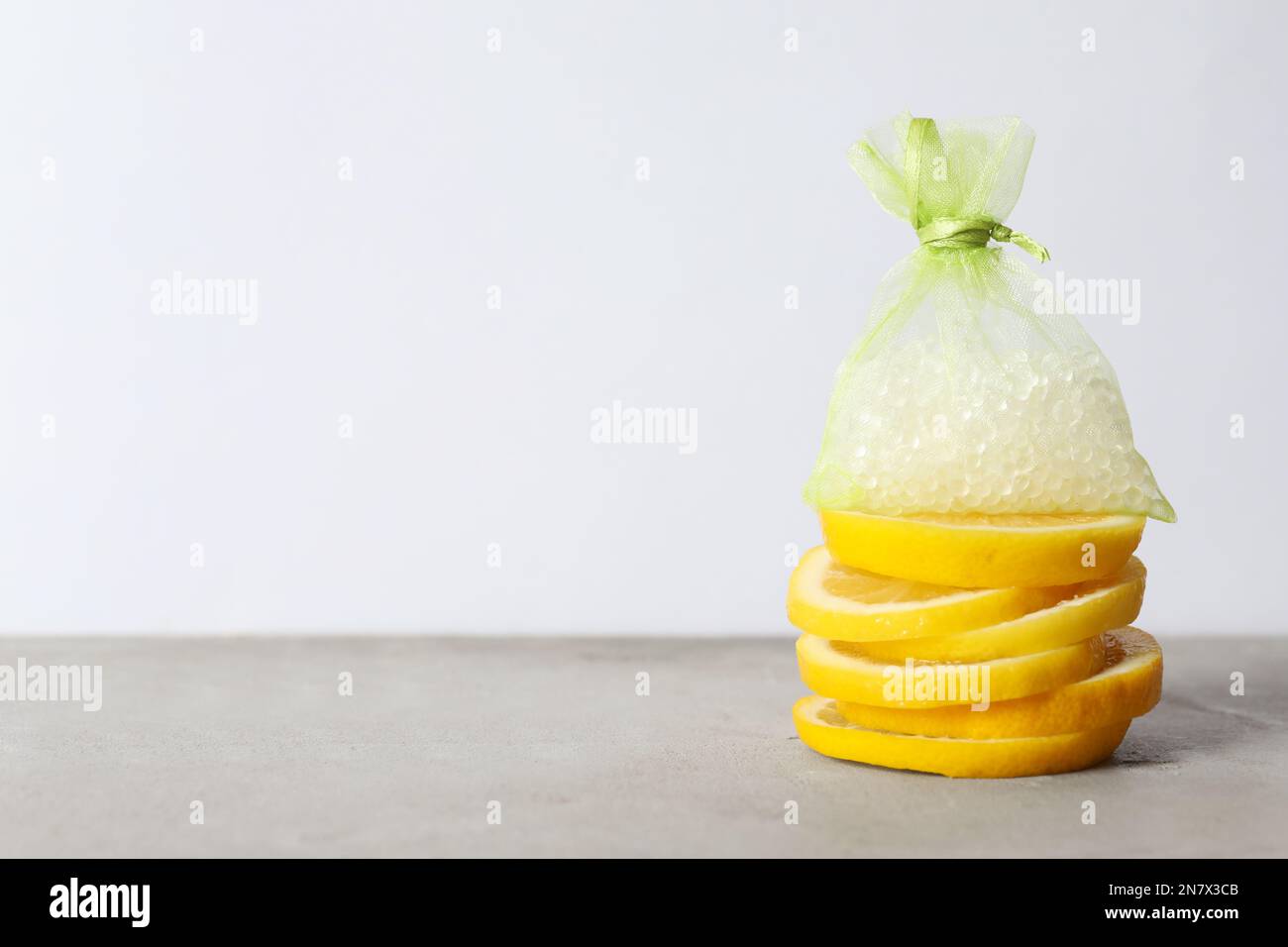 Scented sachet with aroma beads and slices of lemon on grey table, space  for text Stock Photo - Alamy