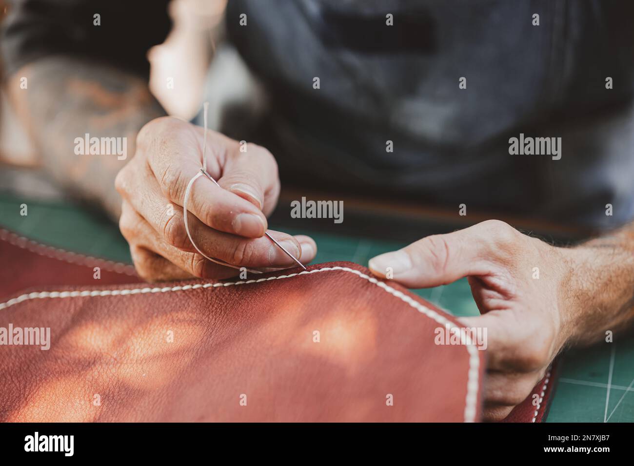 closeup hand working process leather handcraft in the leather