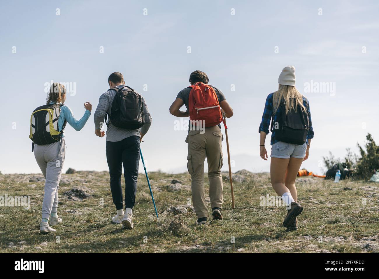 Four friends hiking at the top of the mountain Stock Photo - Alamy