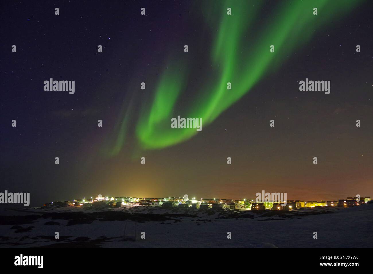 Northern Lights (aurora borealis) over the lights of a city, winter, capital, Nuuk, North