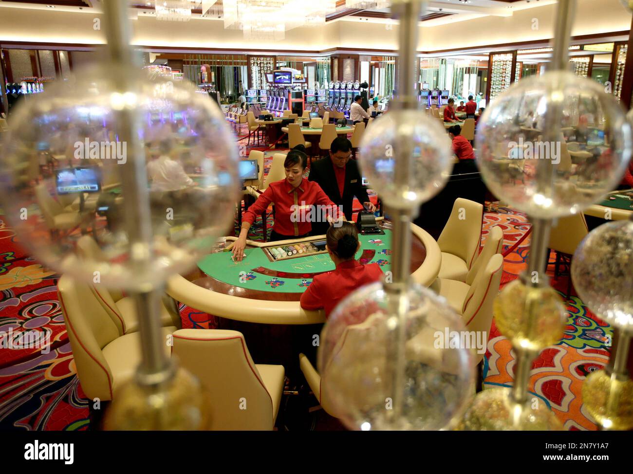 Casino dealers work on their respective games during a media tour of the  new Solaire Resort and Casino, one of the country's biggest casino  complexes, Thursday, March 14, 2013, in suburban Pasay, image size:1300x974