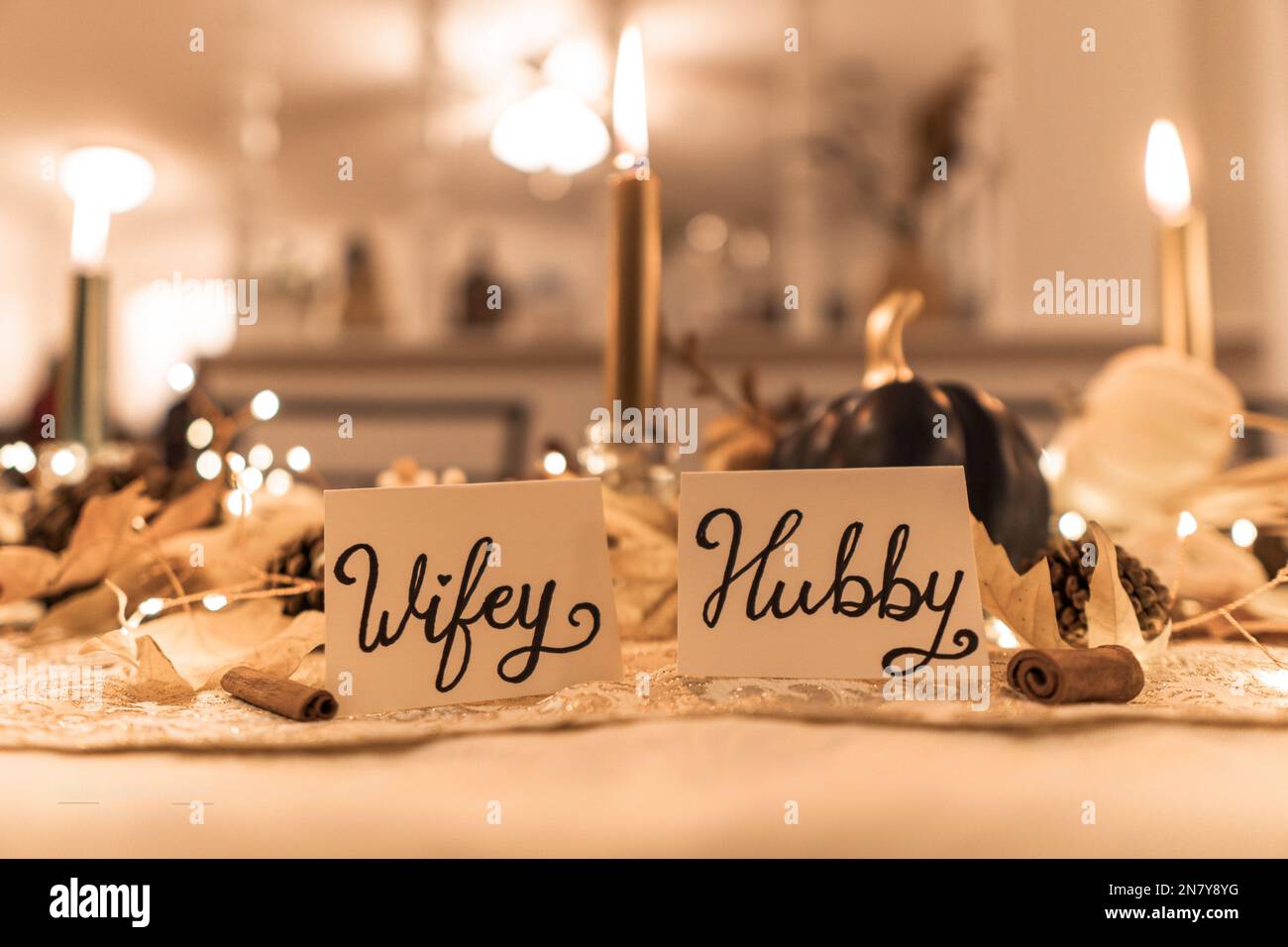 The Wifey and Hubby decorations put on the Thanksgiving dinner table on blurred background Stock Photo