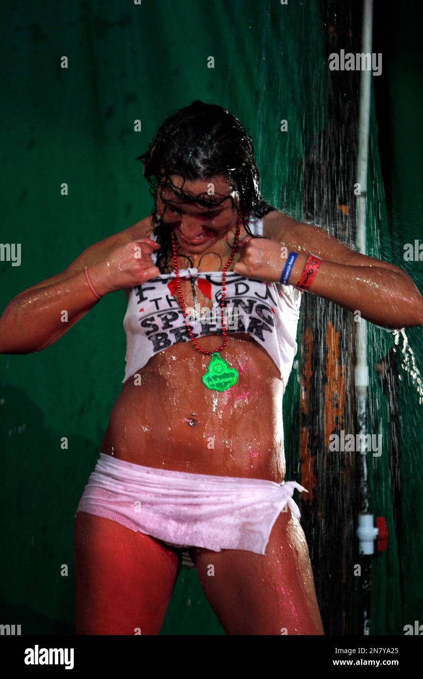A Spring Break reveler rips off her T-shirt during a wet T-shirt contest at  a nightclub in the resort city of Cancun, Mexico, early March 12, 2013.  Cancun is one of the