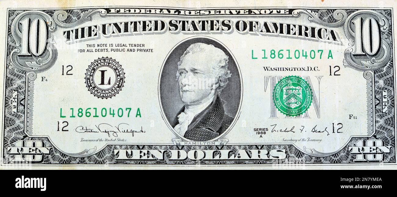 Large fragment of the obverse side of old 10 $ ten American dollars bill banknote series 1988 features the portrait of Alexander Hamilton, who served Stock Photo