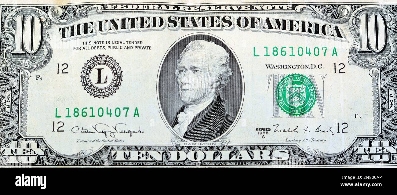 Large fragment of the obverse side of old 10 $ ten American dollars bill banknote series 1988 features the portrait of Alexander Hamilton, who served Stock Photo