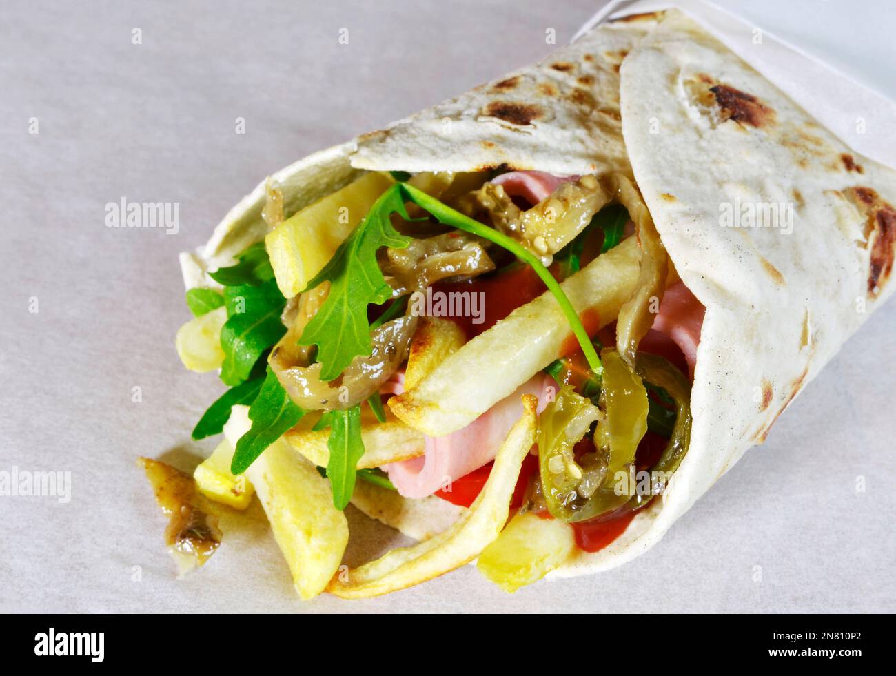Italian food piadina with mortadella and vegetables, thin Italian