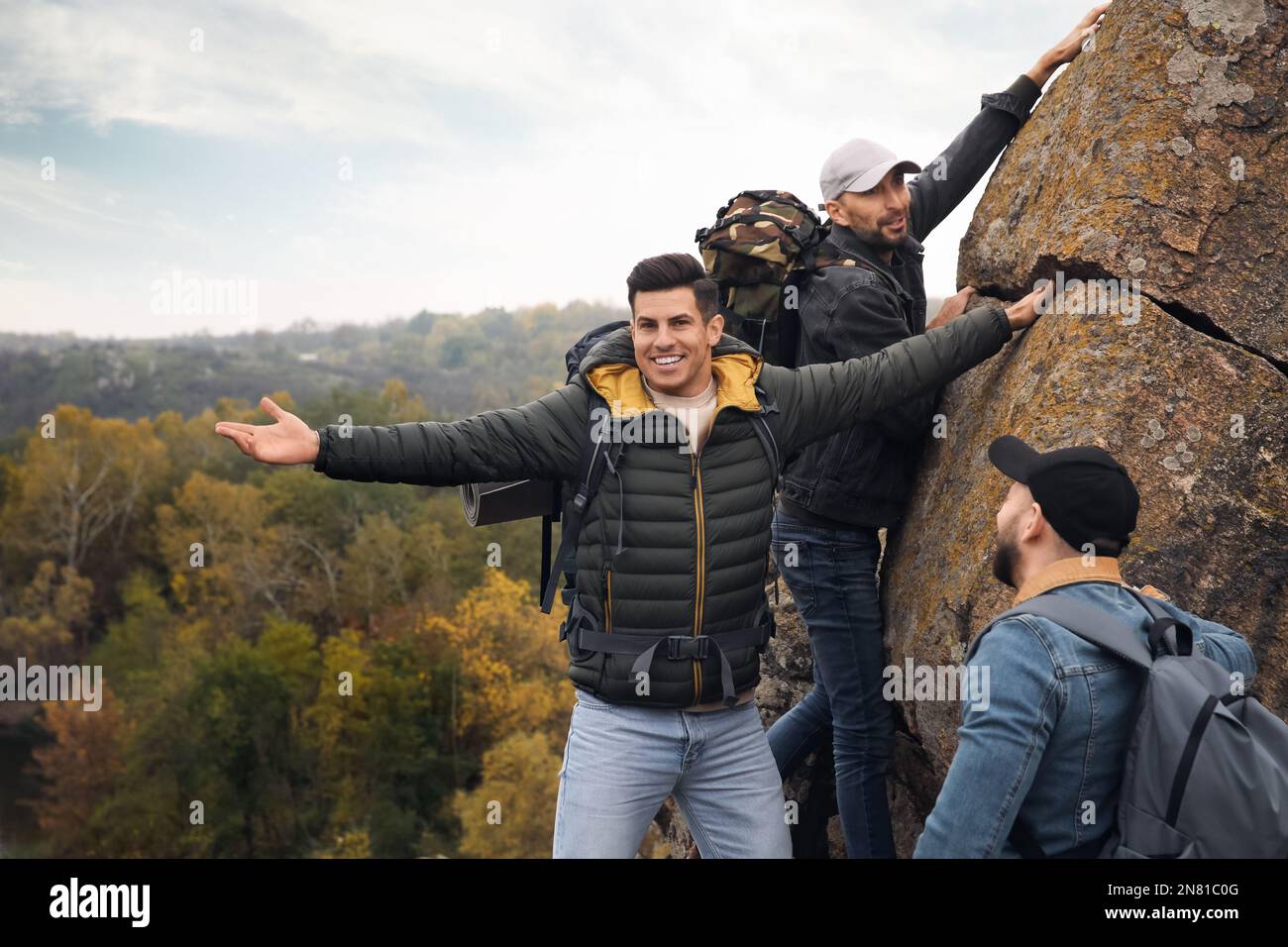 Group of hikers with backpacks climbing up mountains Stock Photo - Alamy