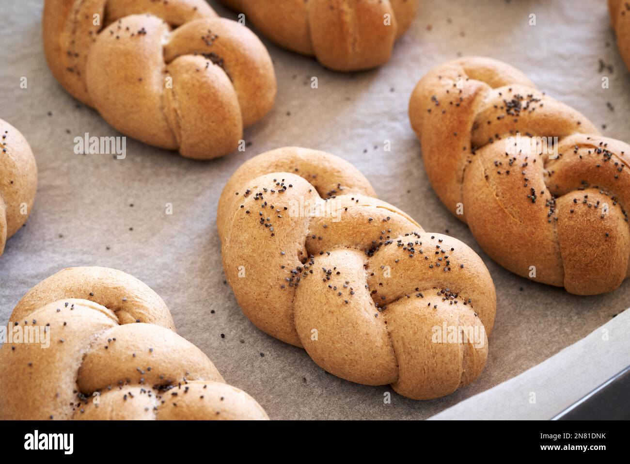 Homemade braided bread rolls made from whole grain spelt flour on a