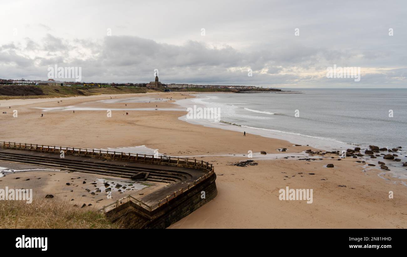 View over Tynemouth Longsands, Tynemouth, UK, with the old outdoor swimming pool in the foreground. Stock Photo