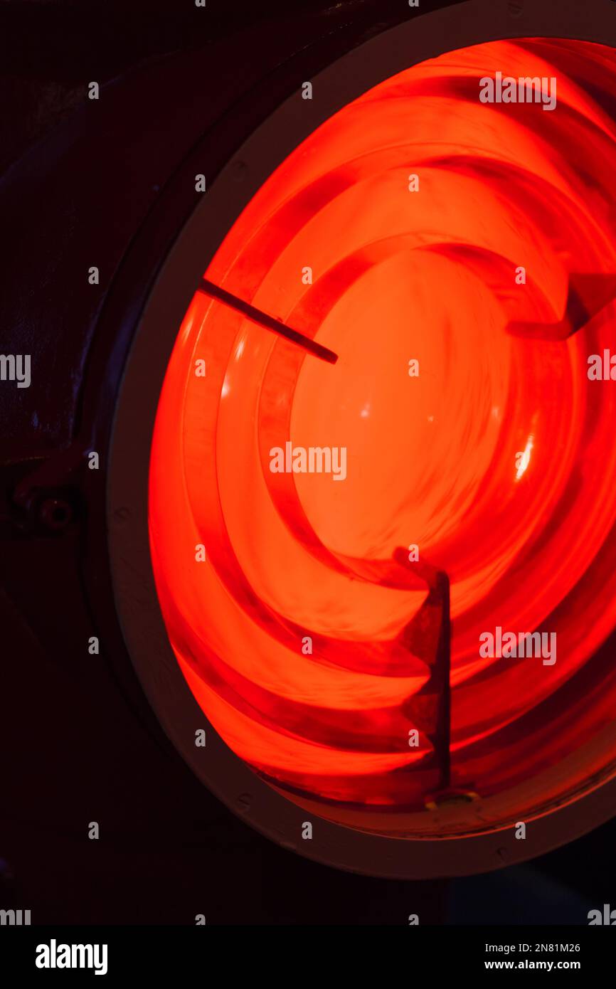 Red lighthouse leading light is behind a Fresnel lens. It is a type of composite compact lens developed by the French physicist Augustin-Jean Fresnel Stock Photo