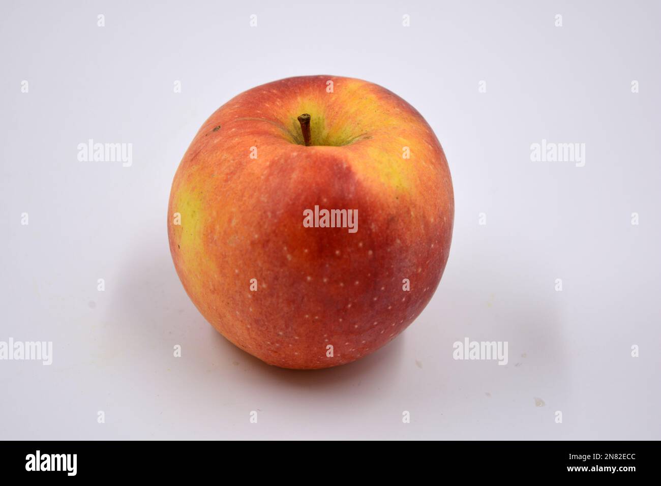 One ripe red yellow apple, a sweet fruit arranged on a white background ...