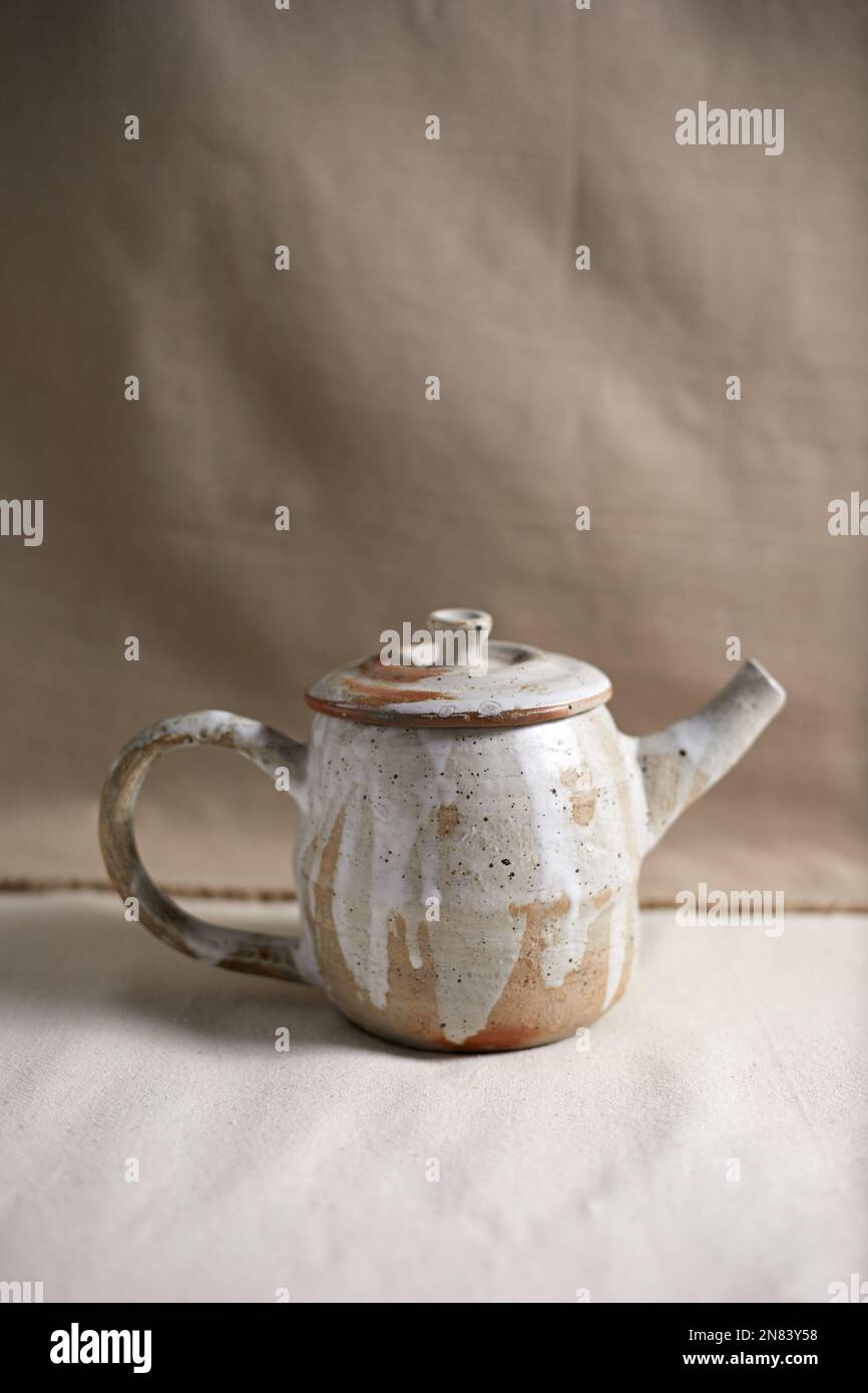 Handmade empty craft ceramic on  textile background. Stock Photo