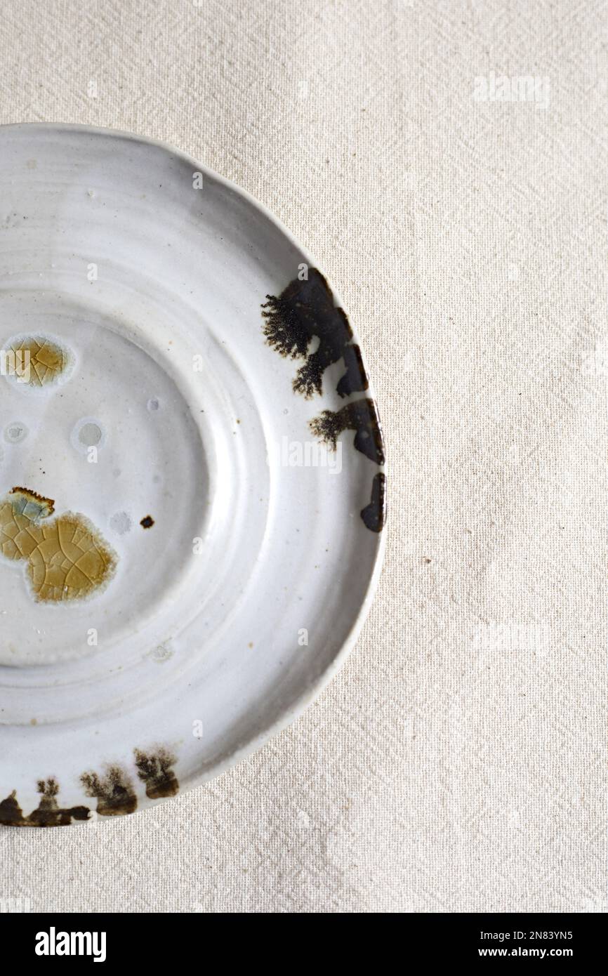 Handmade empty craft ceramic on  textile background. Stock Photo