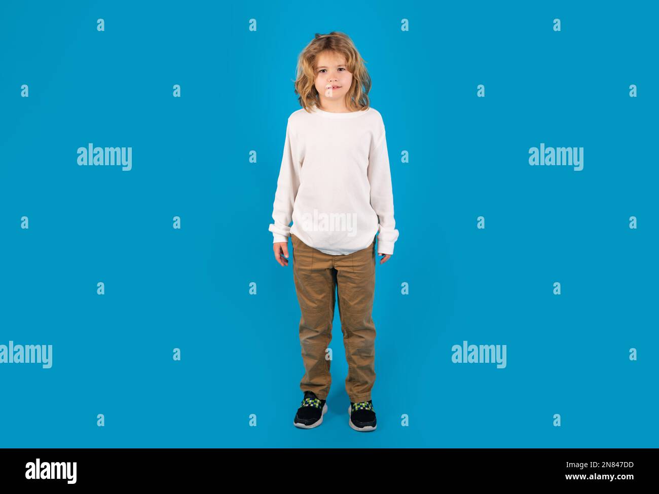 Full size photo of school kid isolated on blue background. Stock Photo