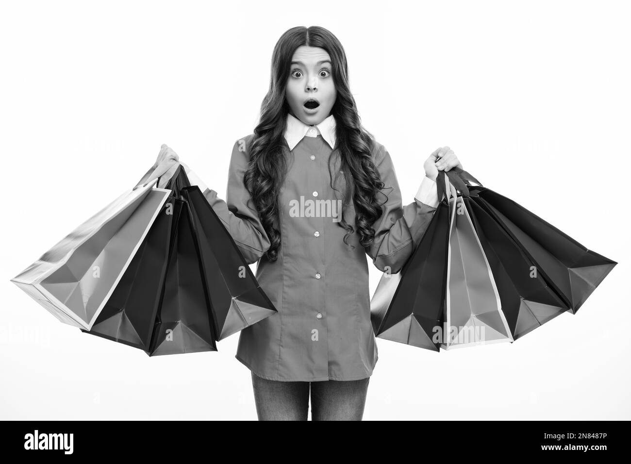Surprised face. Sale and shopping concept. Teen girl holding shopping ...