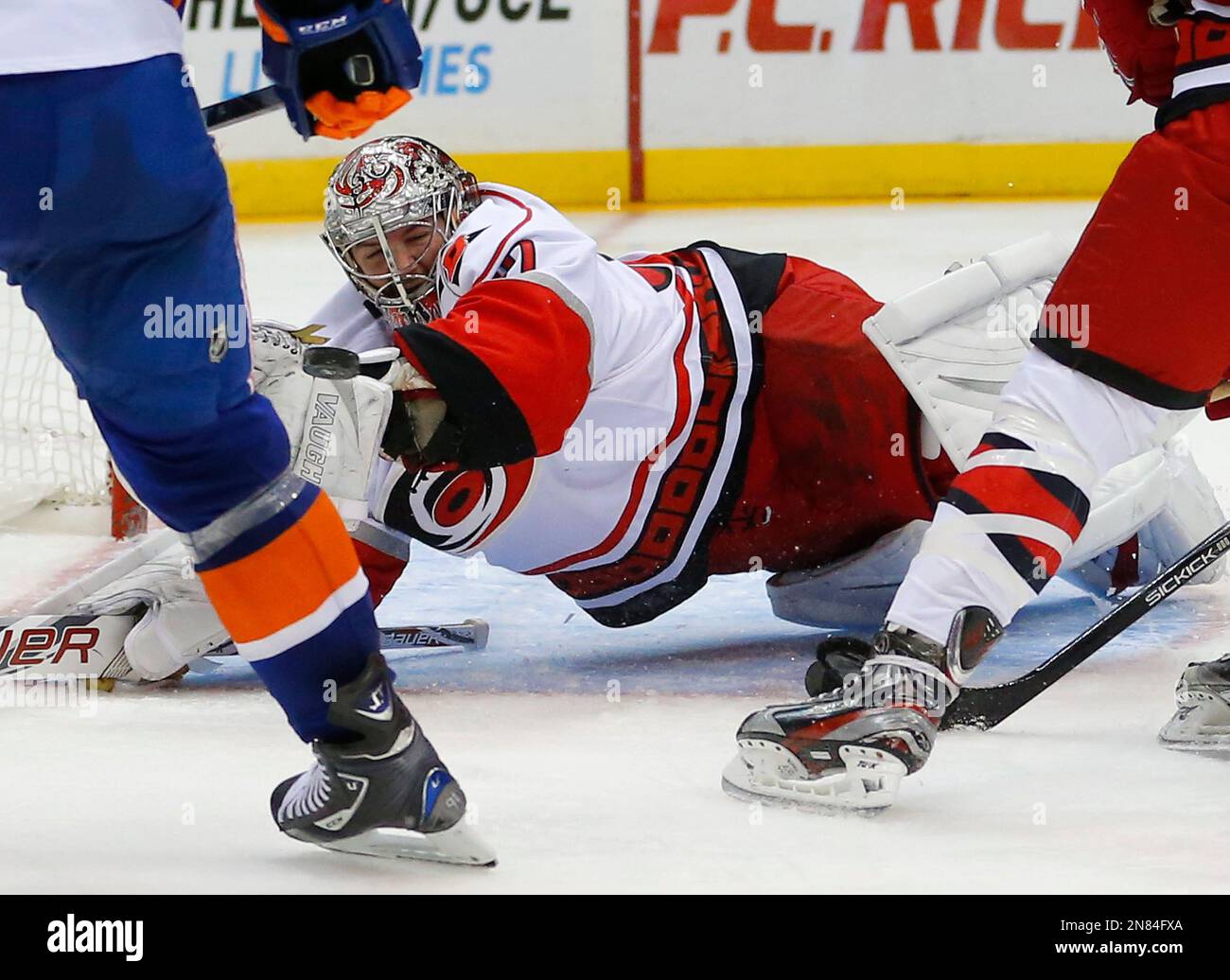 Carolina Hurricanes goalie Cam Ward (30) dives for the puck during the