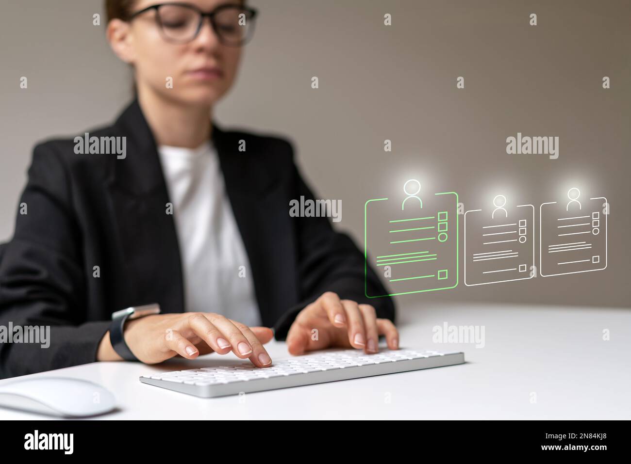 Human resource manger working on computer with virtual infographic