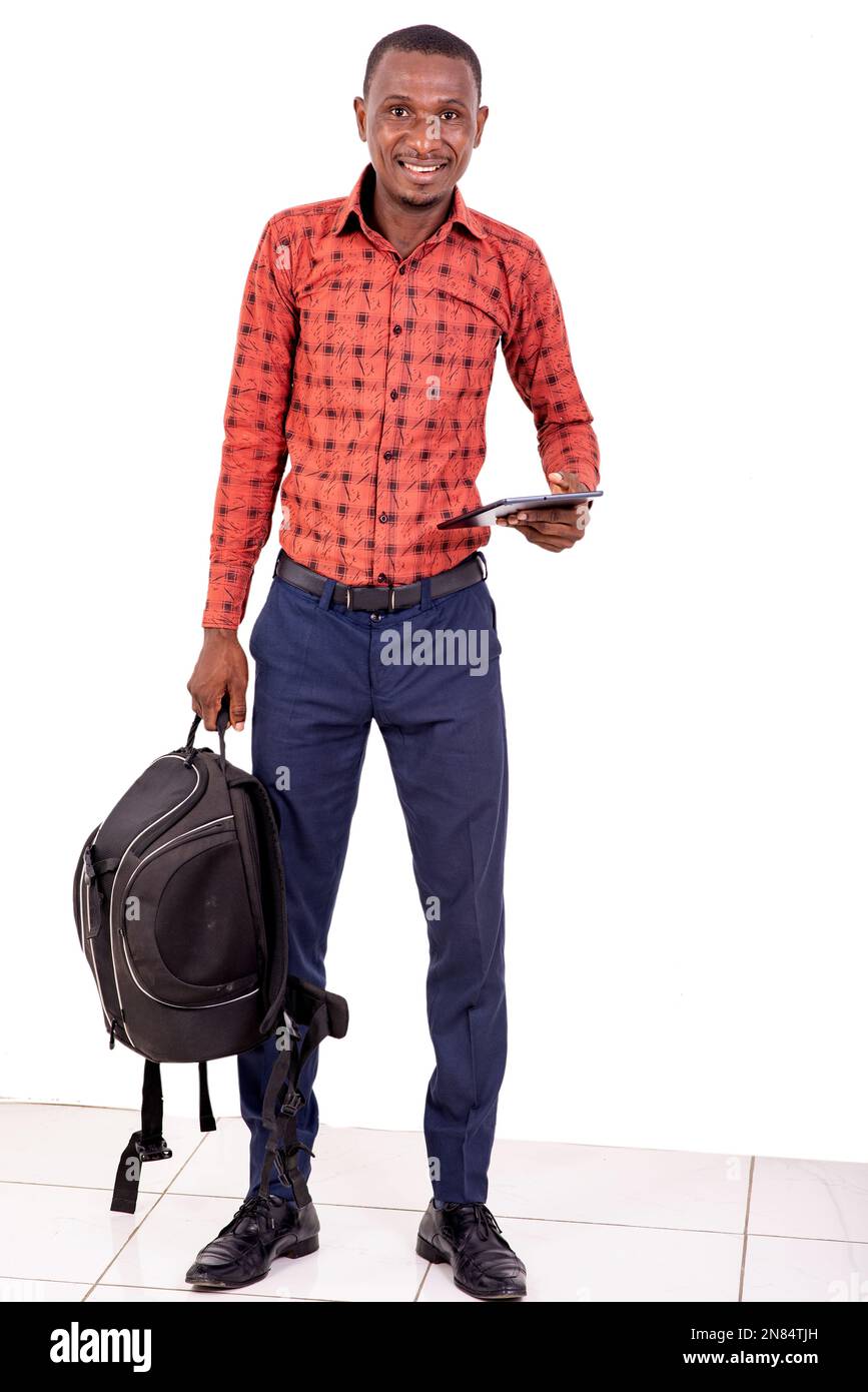 young man holding backpack and digital tablet while smiling at camera. Stock Photo