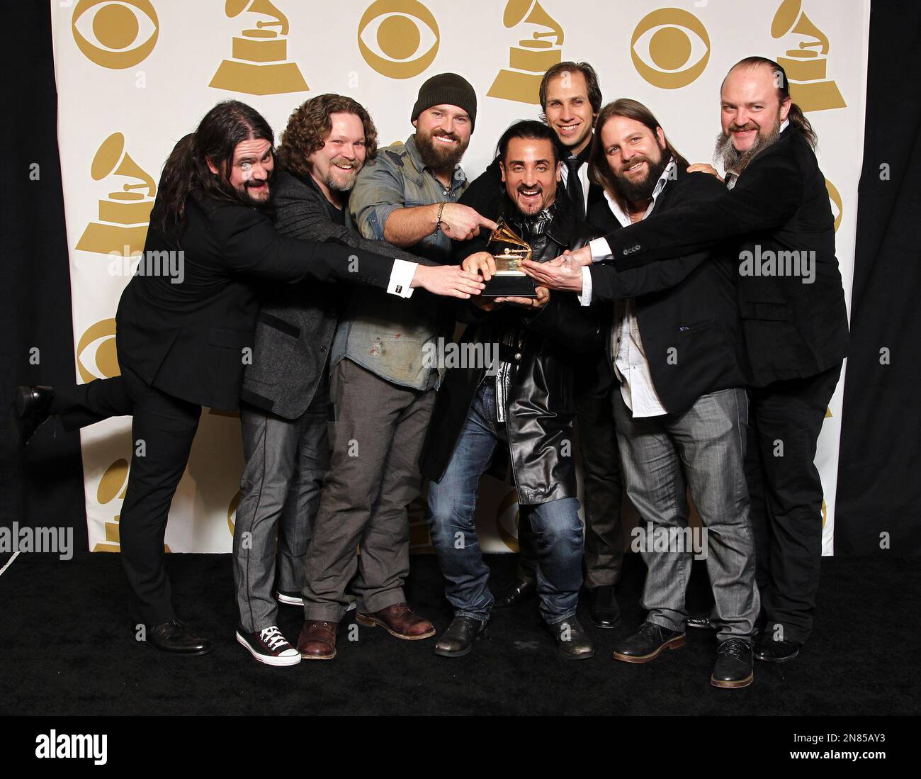 The Zac Brown Band poses backstage with the award for Best Country