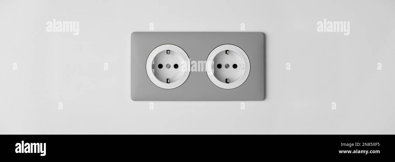 Stylish gray Electric Outlet. Power outlet on the wall. Euro type electric outlet on wall. Stock Photo