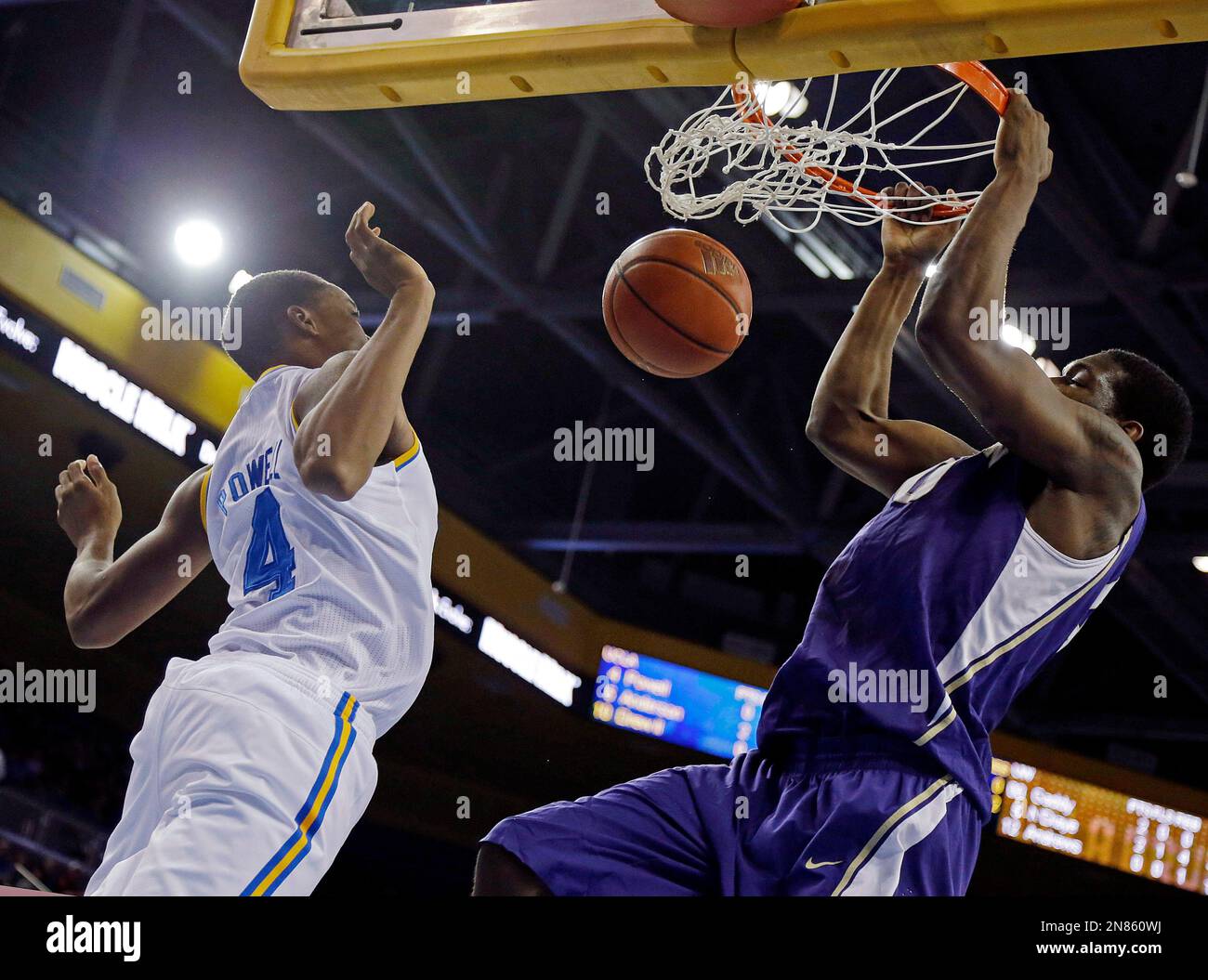 Washington forward Shawn Kemp Jr., right, dunks over UCLA guard Norman