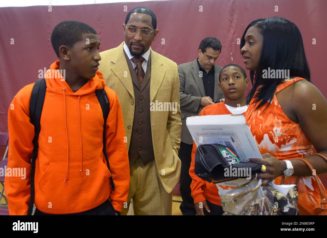 Former Baltimore Ravens linebacker Ray Lewis Jr., second from left, his sons  Rayshad, 14, left, Rahsaan, 12, second from right, and the mother Lewis'  three sons, Tatyana McCall, arrive for a national