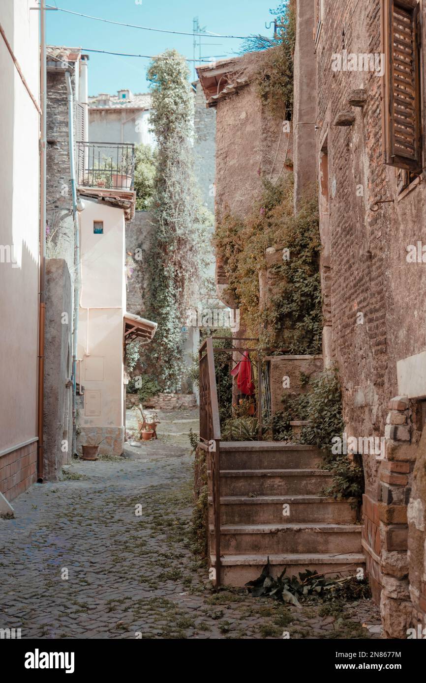 A vertical shot of a narrow street with old residential buildings in ...